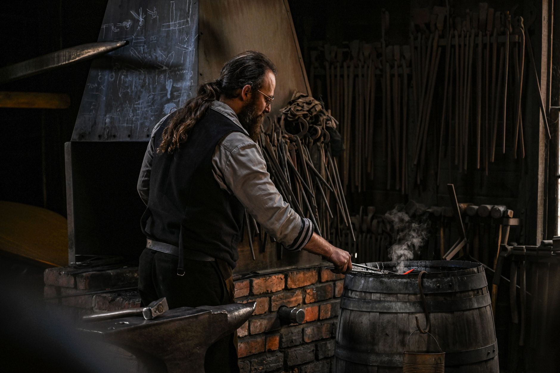 Ironsmith at work in the forge, shaping hot metal